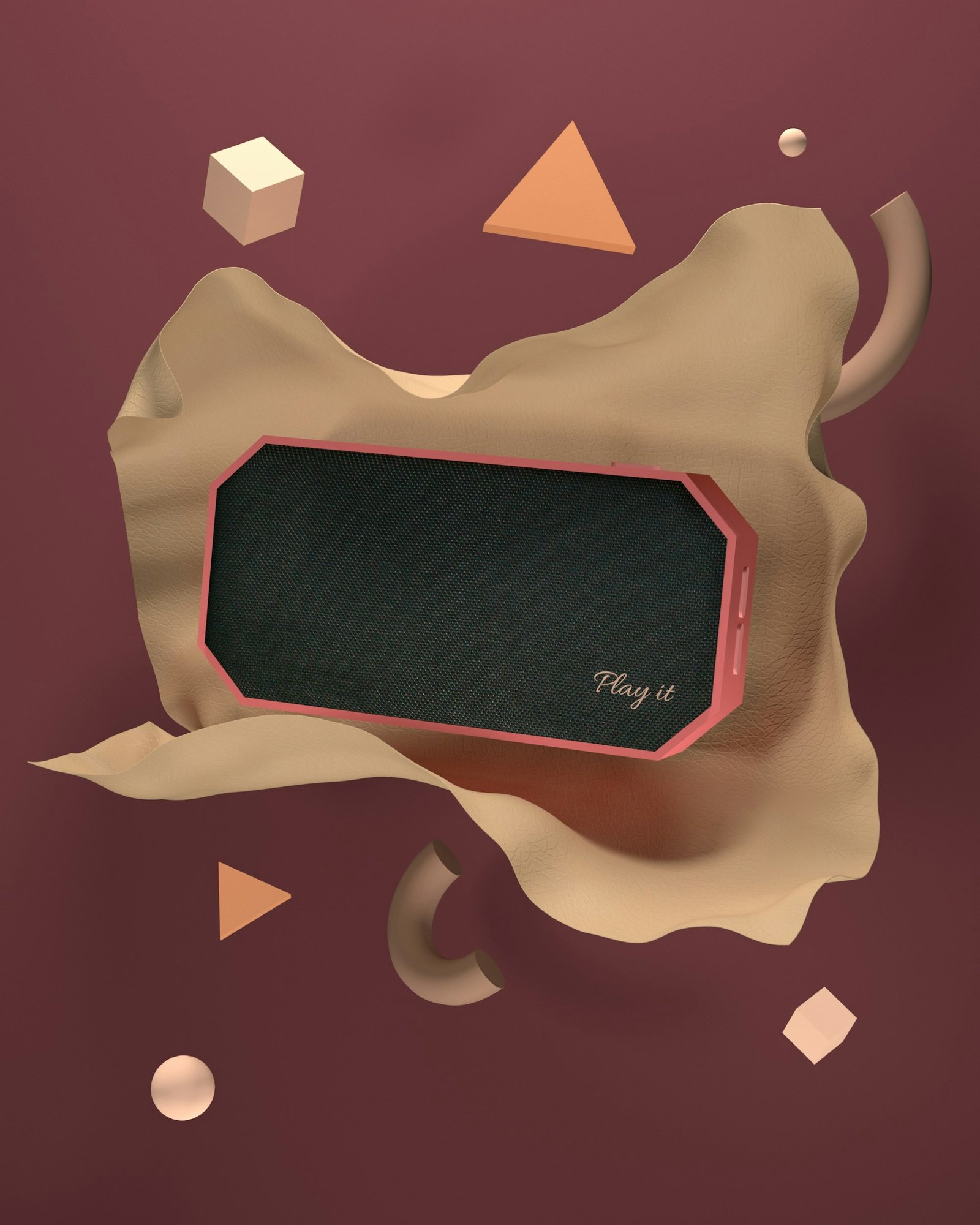 3D render: a coral portable speaker set into draped sand-coloured cloth